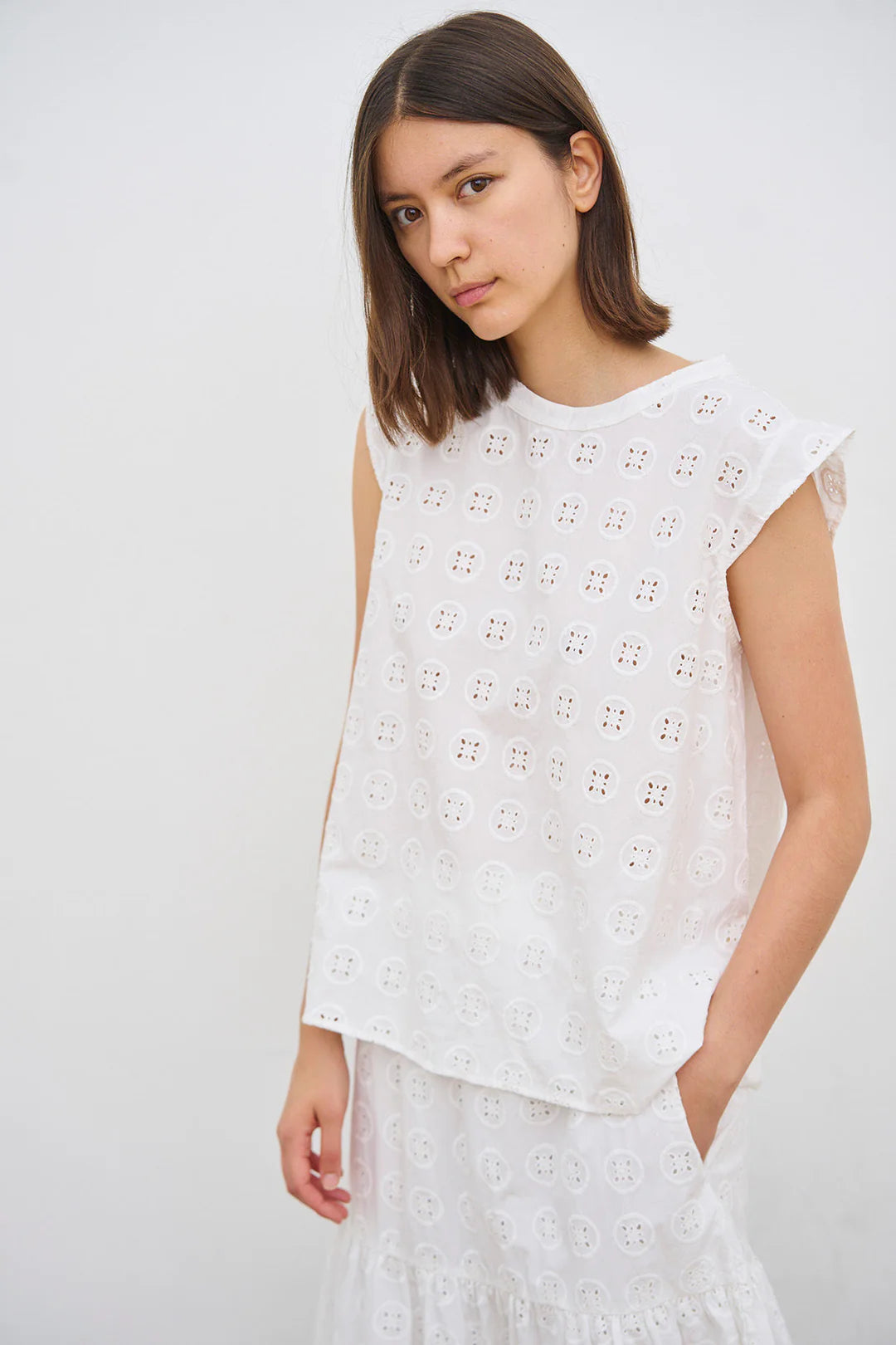 Klassisk top med rund hals og uden ærmer. Overdelen har det smukkeste broderi anglaise, som kan kombineres med nederdel i samme mønster.