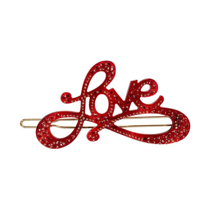 Hårnål, hvor der står Love i rød med rhinsten.
