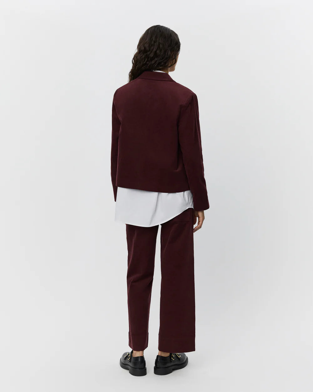 Kort jakke i plumfarvet babyfløjl fra Sofie Schnoor – tætsiddende model med krave, store lommer og knaplukning