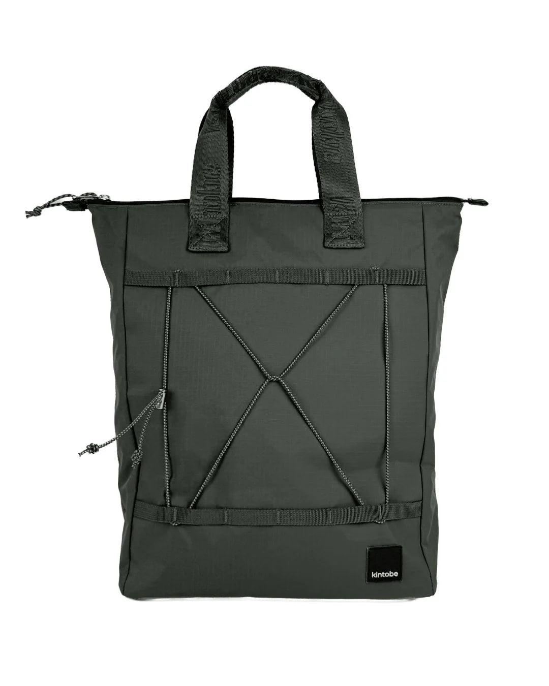 Grøn taske, der kan bruges som tote bag eller rygsæk - og stropper kan skjules. Den har håndtag i toppen, der gør den nem at bære. På toppen sidder lynlåsen, der åbner op til et stort rum med lyst for.